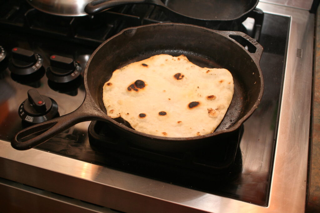 cooking  a flat bread in the skillet