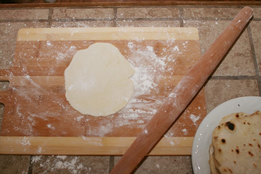 rolling out flat bread dough