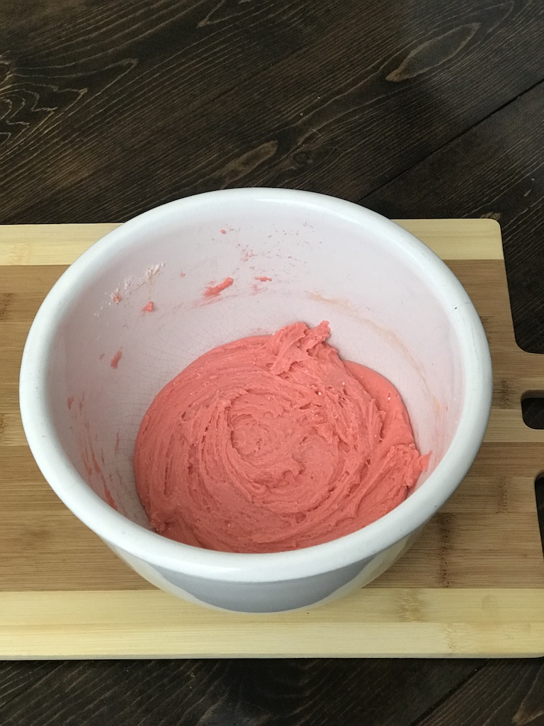 mixed up strawberry brownies in white bowl