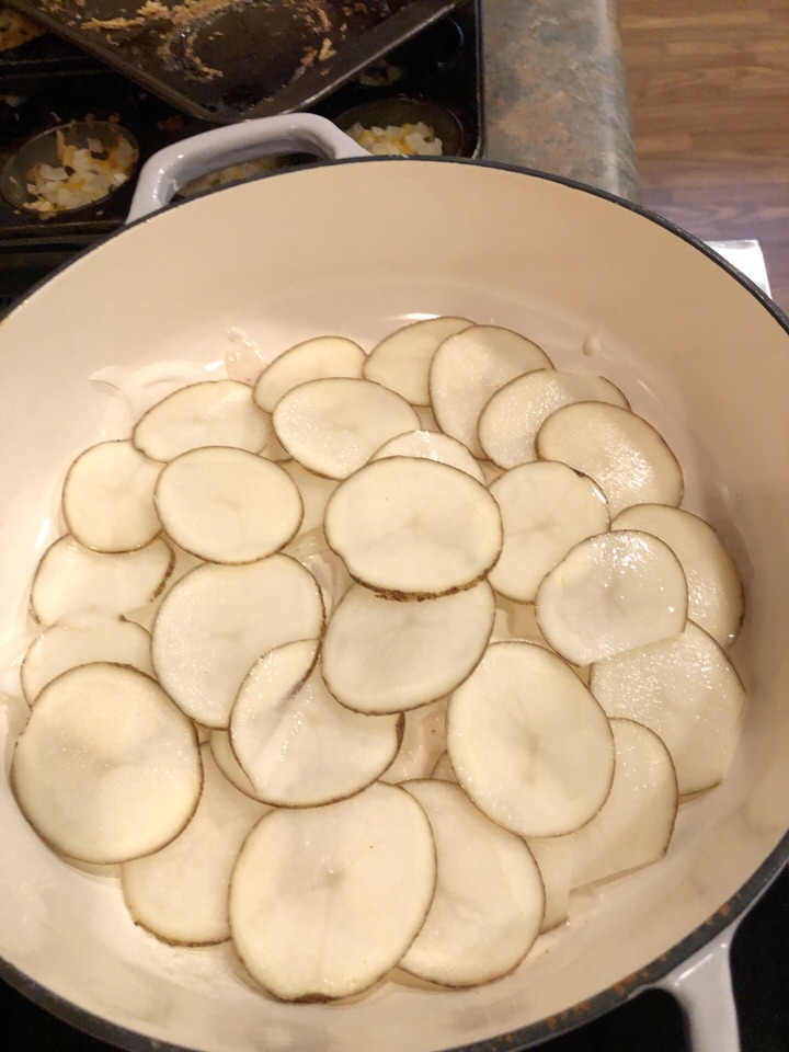 a layer of thinly sliced potatoes