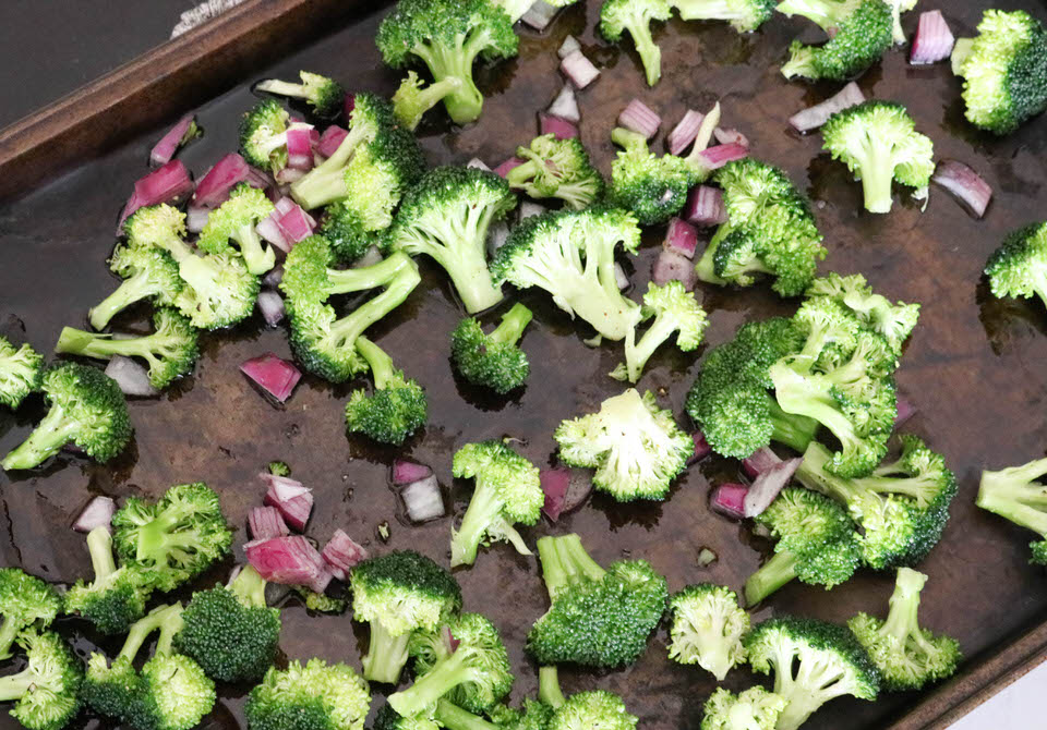broccoli and onion on a sheet pan
