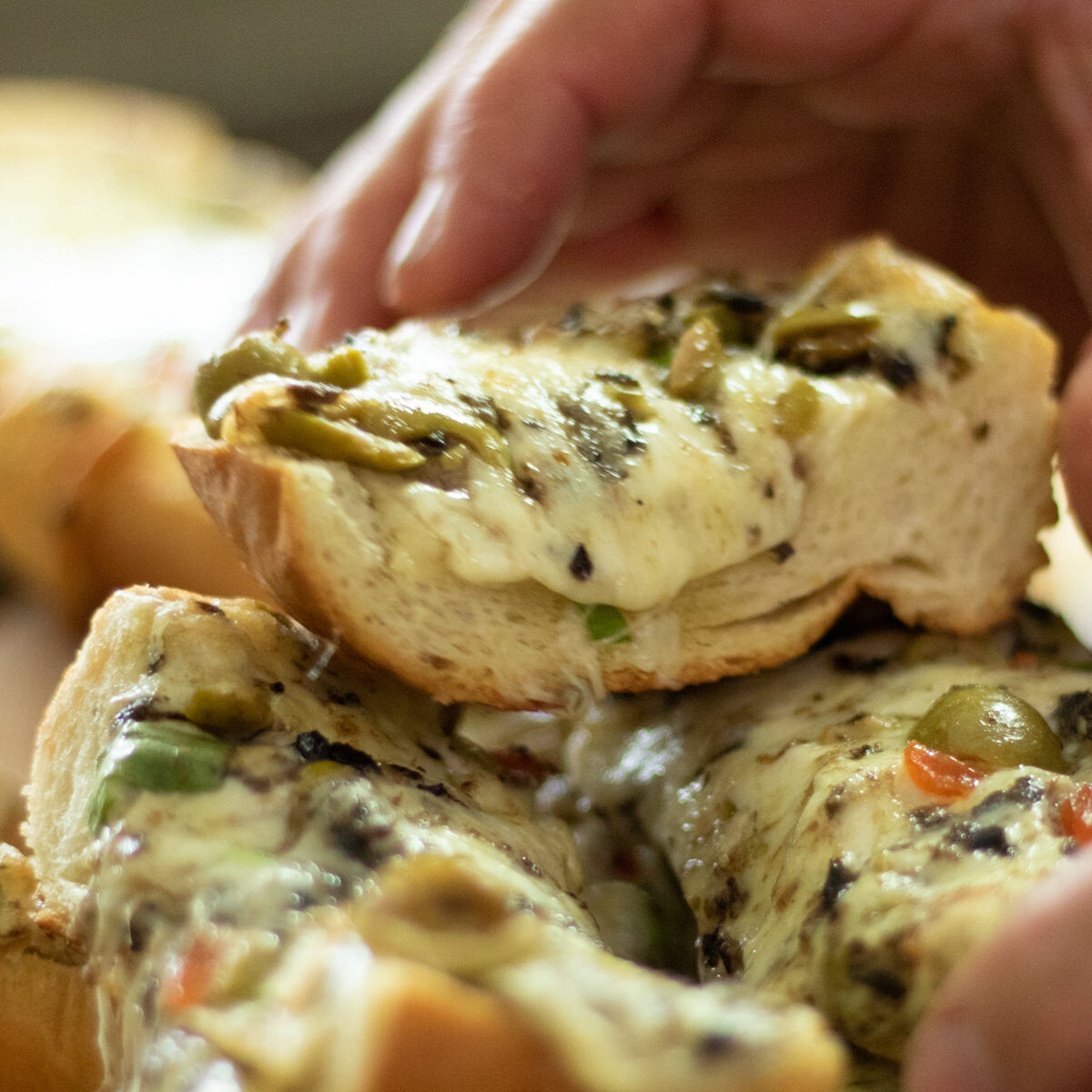 grabbing a piece of cheesy olive bread