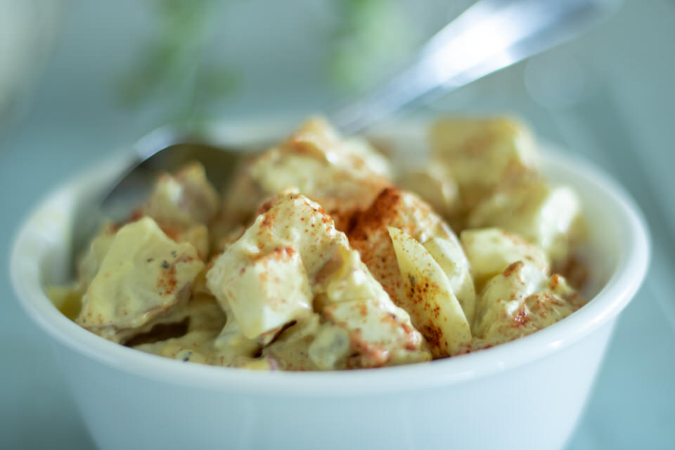 close up of potato salad in a white bowl