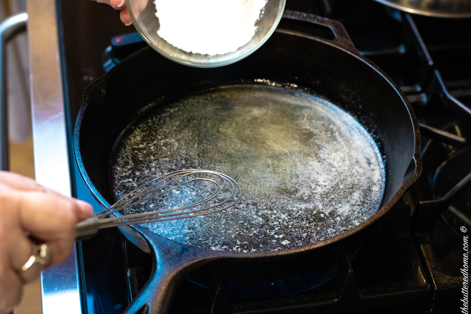 Adding dry ingredients to the skillet.