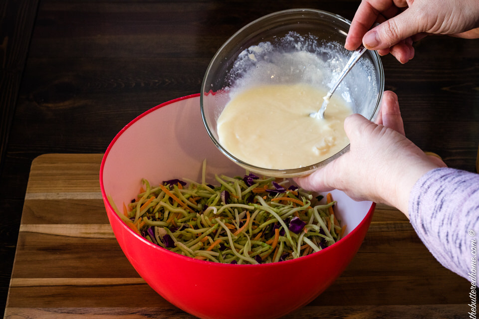 adding dressing to coleslaw vegetables