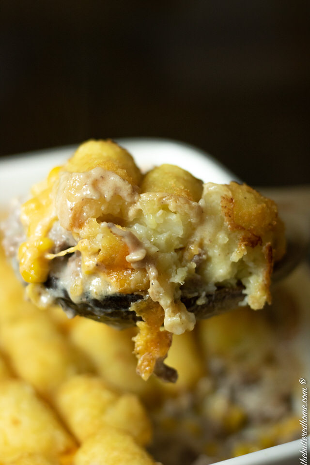 a scoop of Tater tot casserole out of the oven