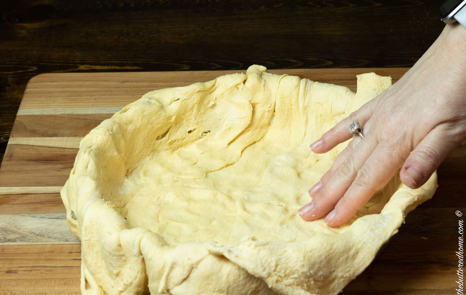 crescent rolls pressed into bottom of pie dish