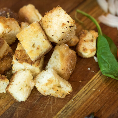 homemade croutons for salad on a cutting board