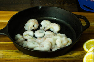 arranging shrimp in cast iron skillet