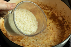 adding rice in with sauce