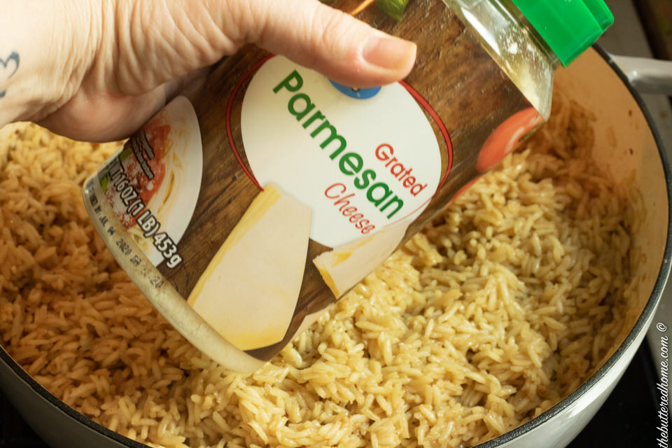 adding parmesan cheese to rice