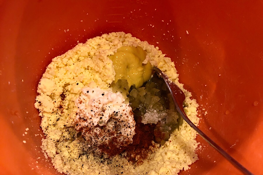 adding mayo, mustard salt pepper paprika and dill pickles
