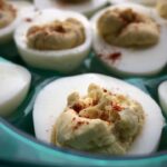green plate of deviled eggs
