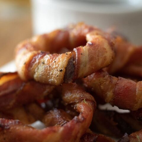 close up picture of finished bacon wrapped onion rings