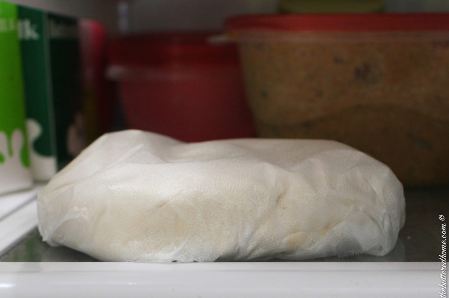 wrapped pie dough resting in the refrigerator