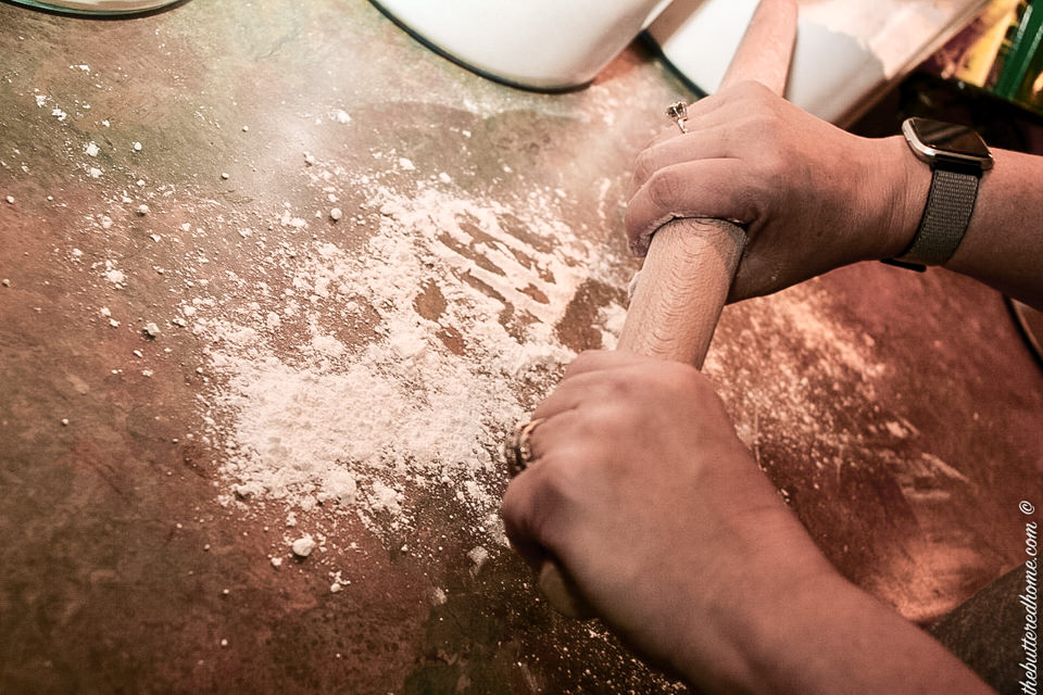 adding flour to the work surface and the rolling pin