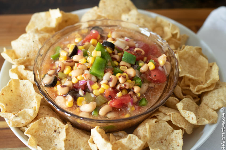 bowl of redneck caviar on a plate with tortilla chips