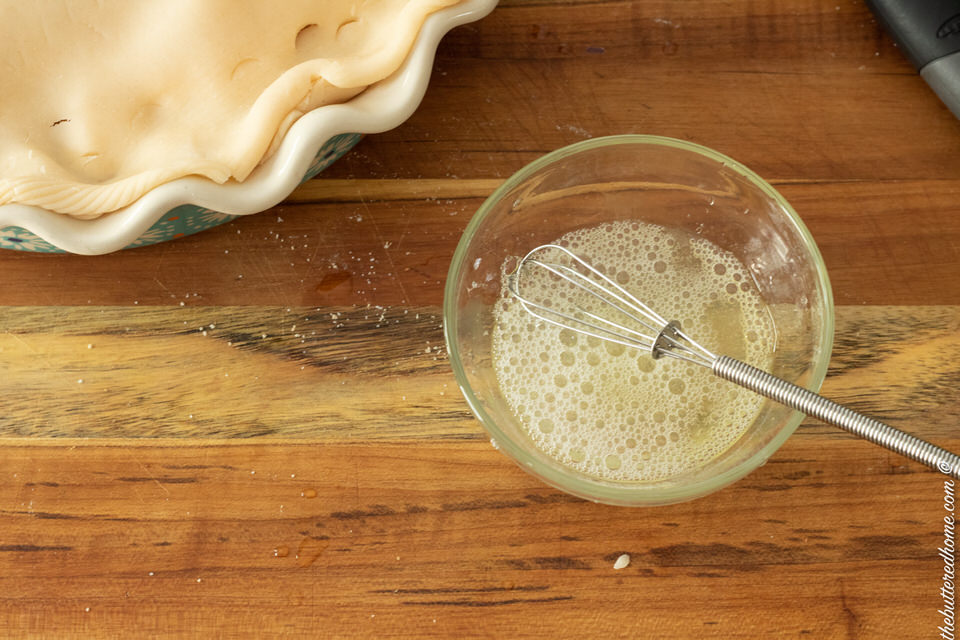 egg white mixed with a tad of water in a small dish