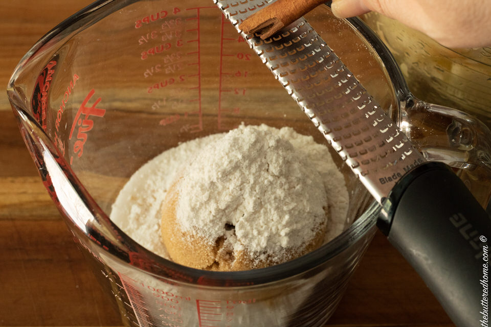 grating cinnamon into dry ingredients