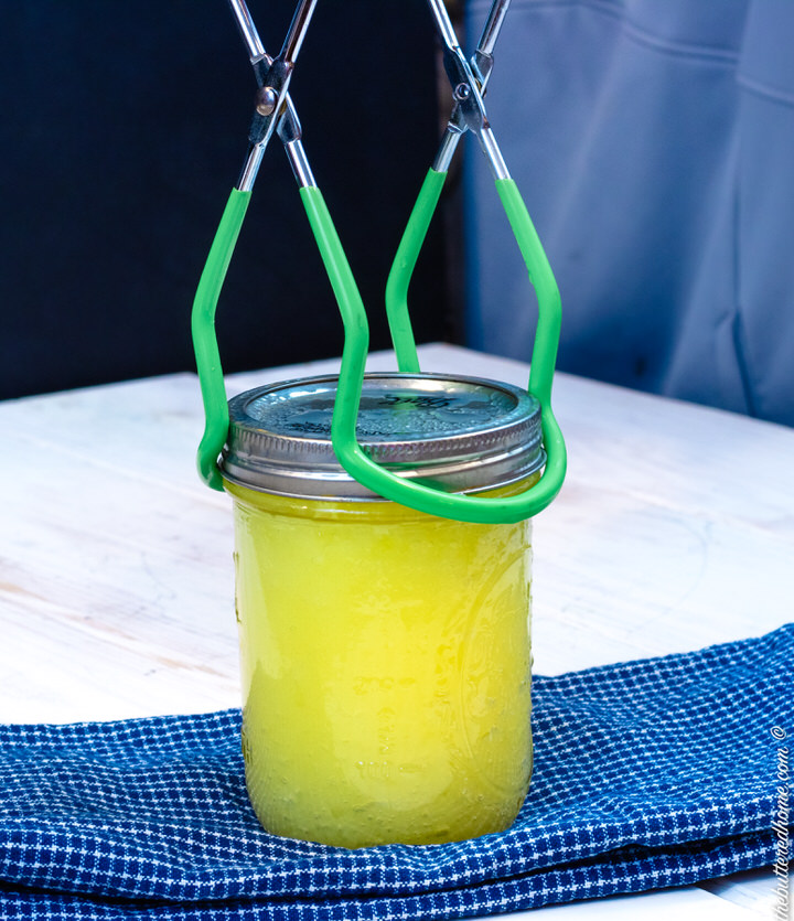 taking lemon curd jar out with tongs