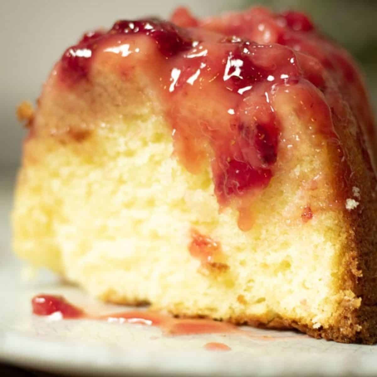 a slice of strawberry upside down cake on a white plate