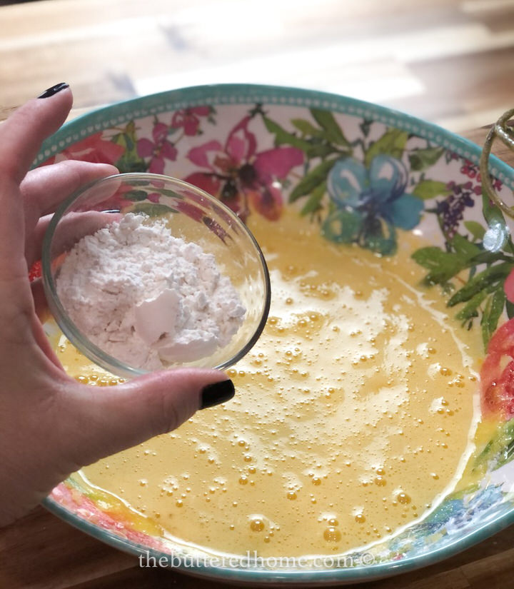 adding flour to eggs and sugar