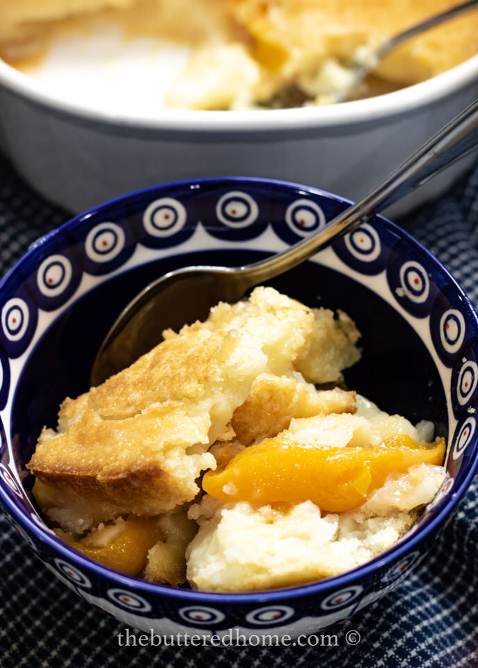 overhead picture of peach cobbler in blue and white bowl