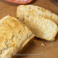 loaf of rosemary bread with two slices cut