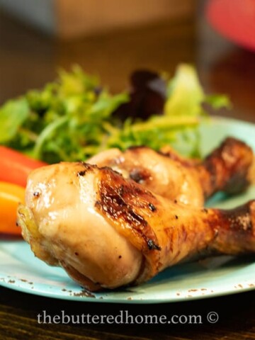 chicken legs bbq on a blue plate
