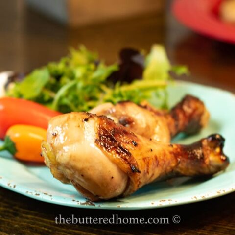 chicken legs bbq on a blue plate