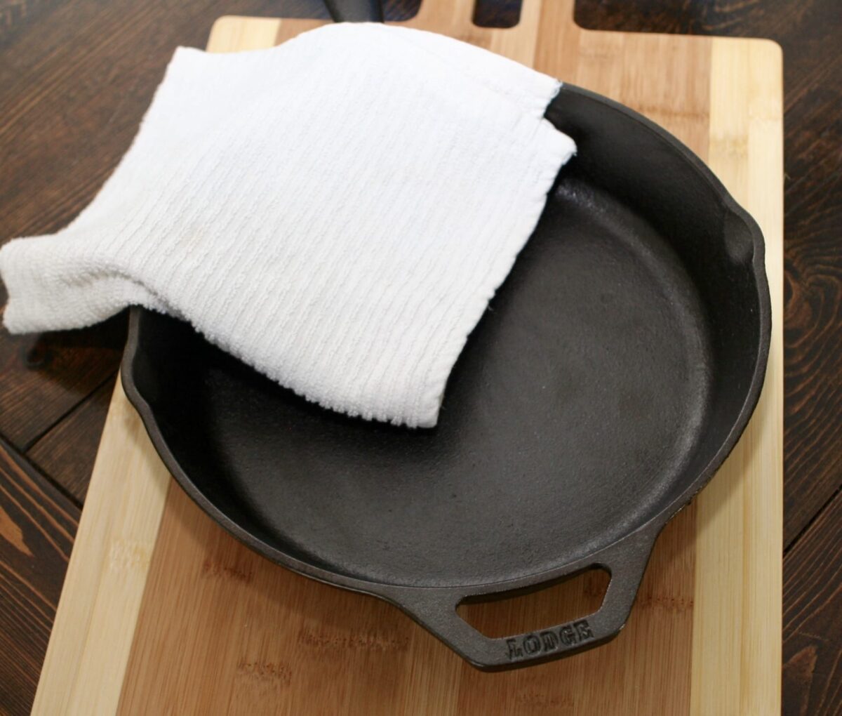 Drying out the skillet with a dry white cloth.