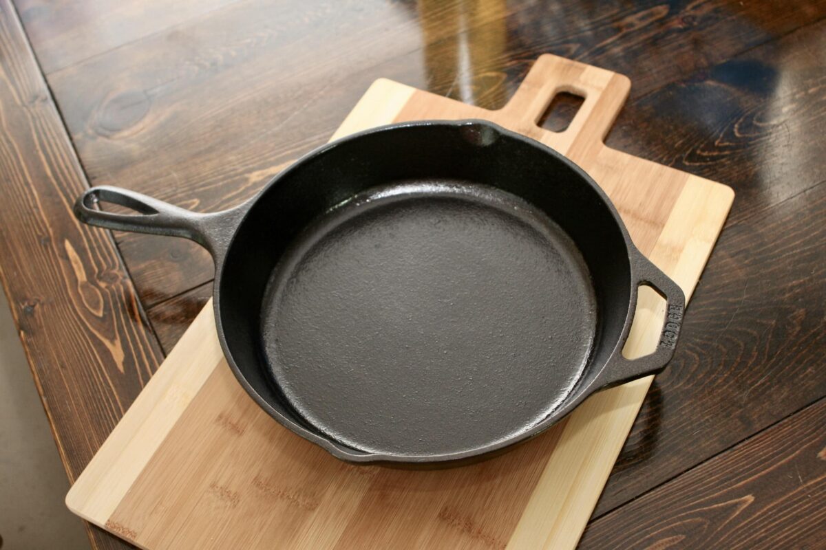 Seasoned pan sitting on a wooden cutting board.