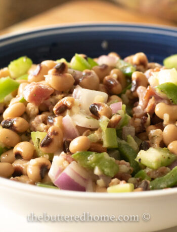 bacon black eyed pea salad in a blue bowl