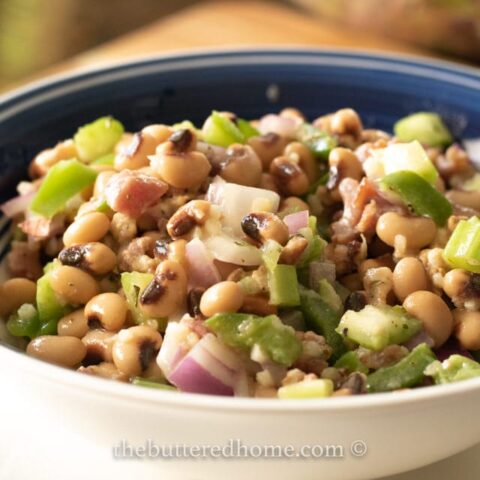 bacon black eyed pea salad in a blue bowl
