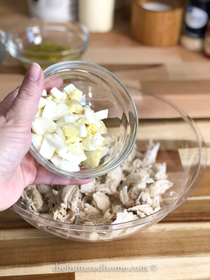 adding chopped boiled eggs