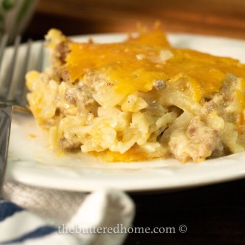 close up of sausage hasqhbrown casserole on a white plate