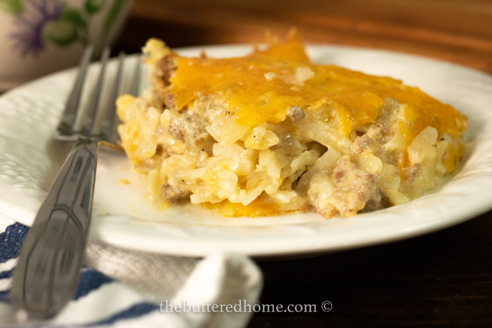 close up of sausage hasqhbrown casserole on a white plate