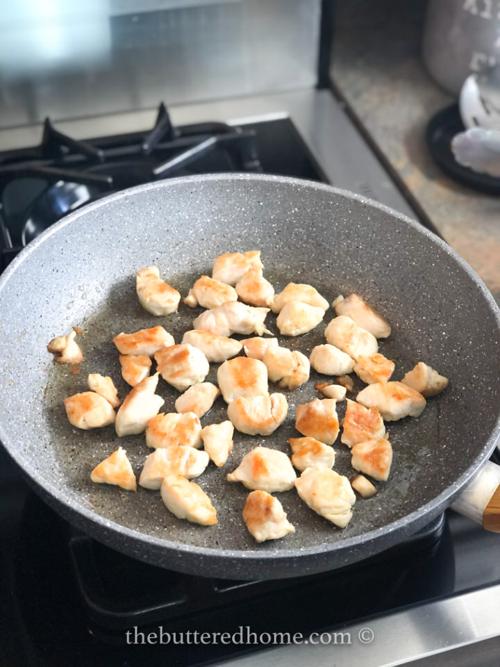 small cuts of chicken breast being pan fried