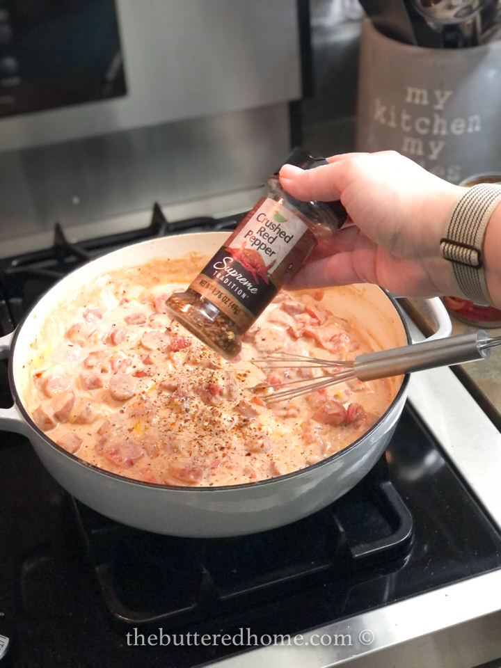 Adding a pinch of red pepper flakes.