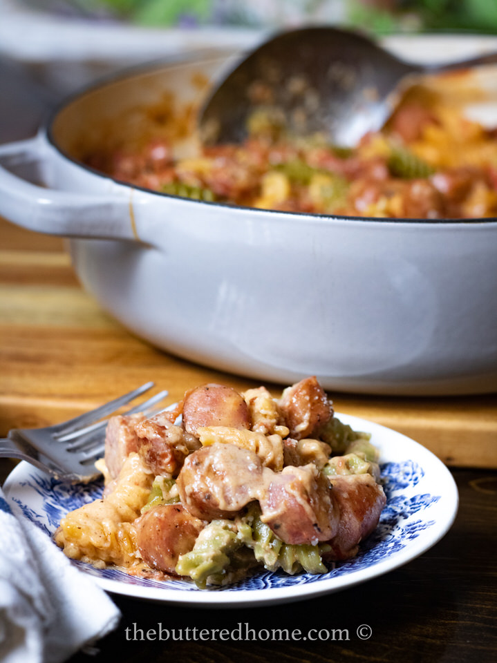 A serving of Conecuh pasta with the whole pan in the background.