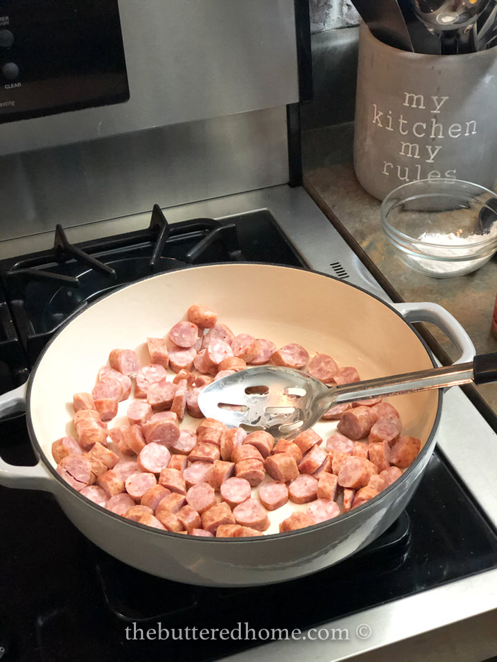cooking the sliced conecuh sausage