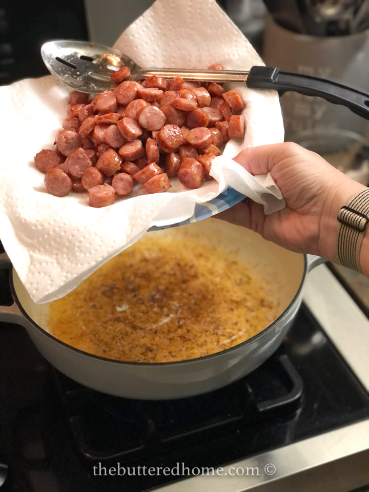 draining the cooked conecuh sausage