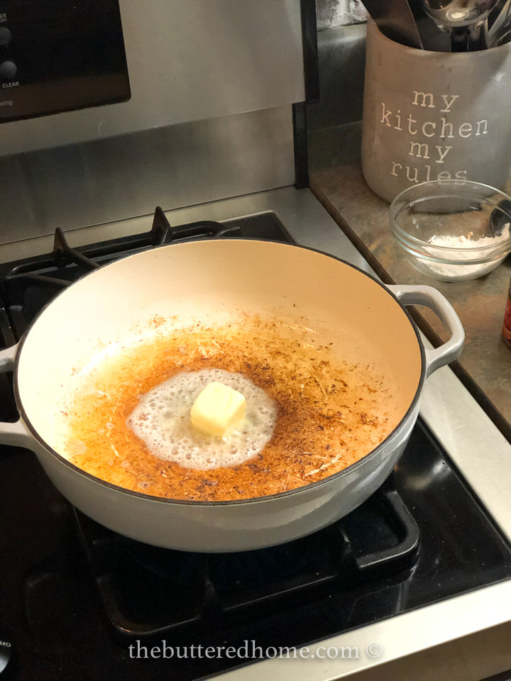 melting butter in the pan with the grease from sausage