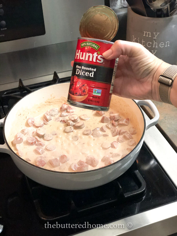 Adding a can of diced tomatoes.