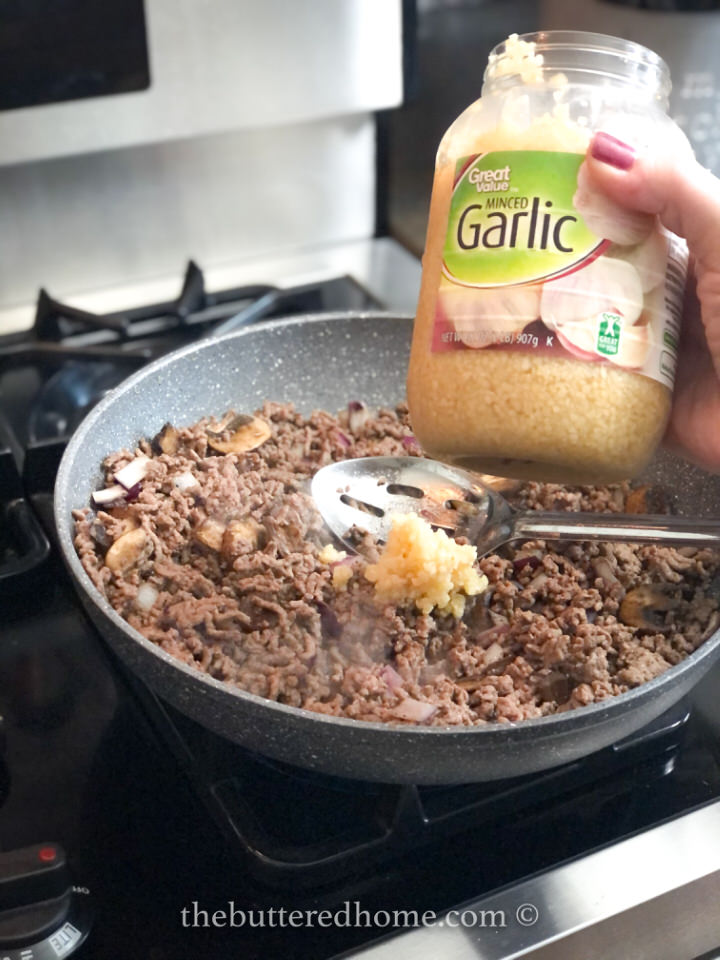 adding minced garlic