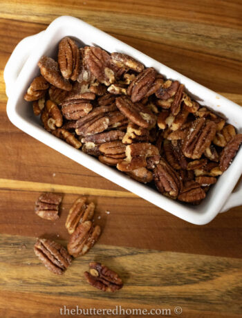 picture from above of a white dish filled with pecans