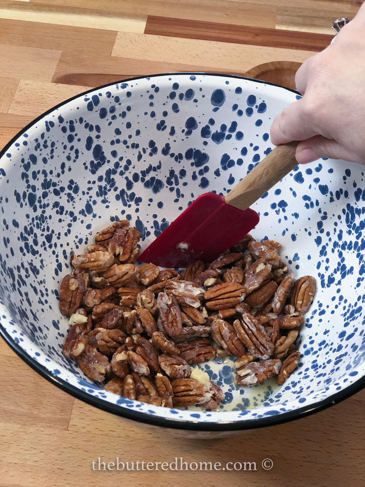 mixing the pecans with butter