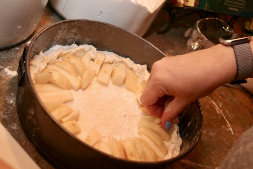 placing sliced pears on pie crust