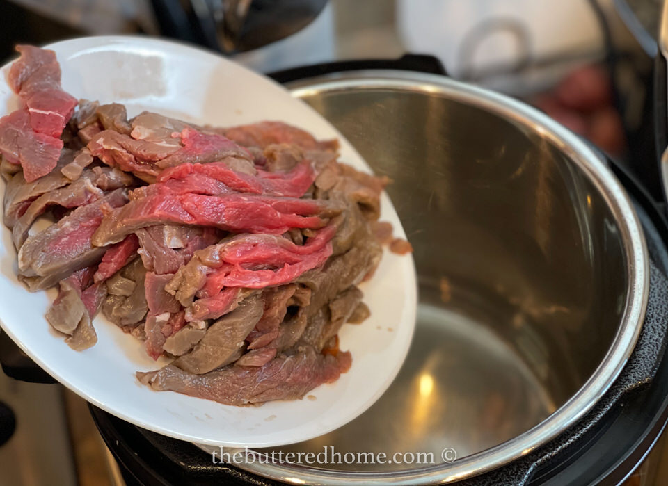 sliced beef on a white plate