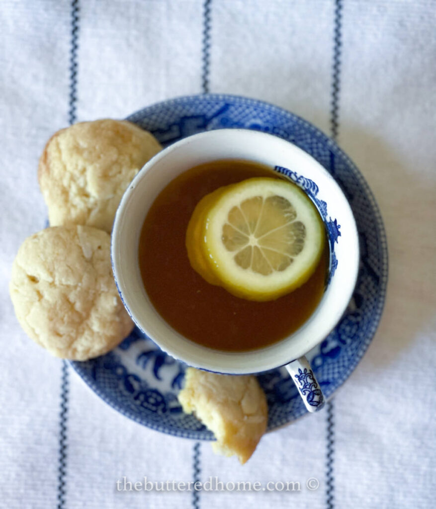 lemon cookies with tea in a blue and white tea service